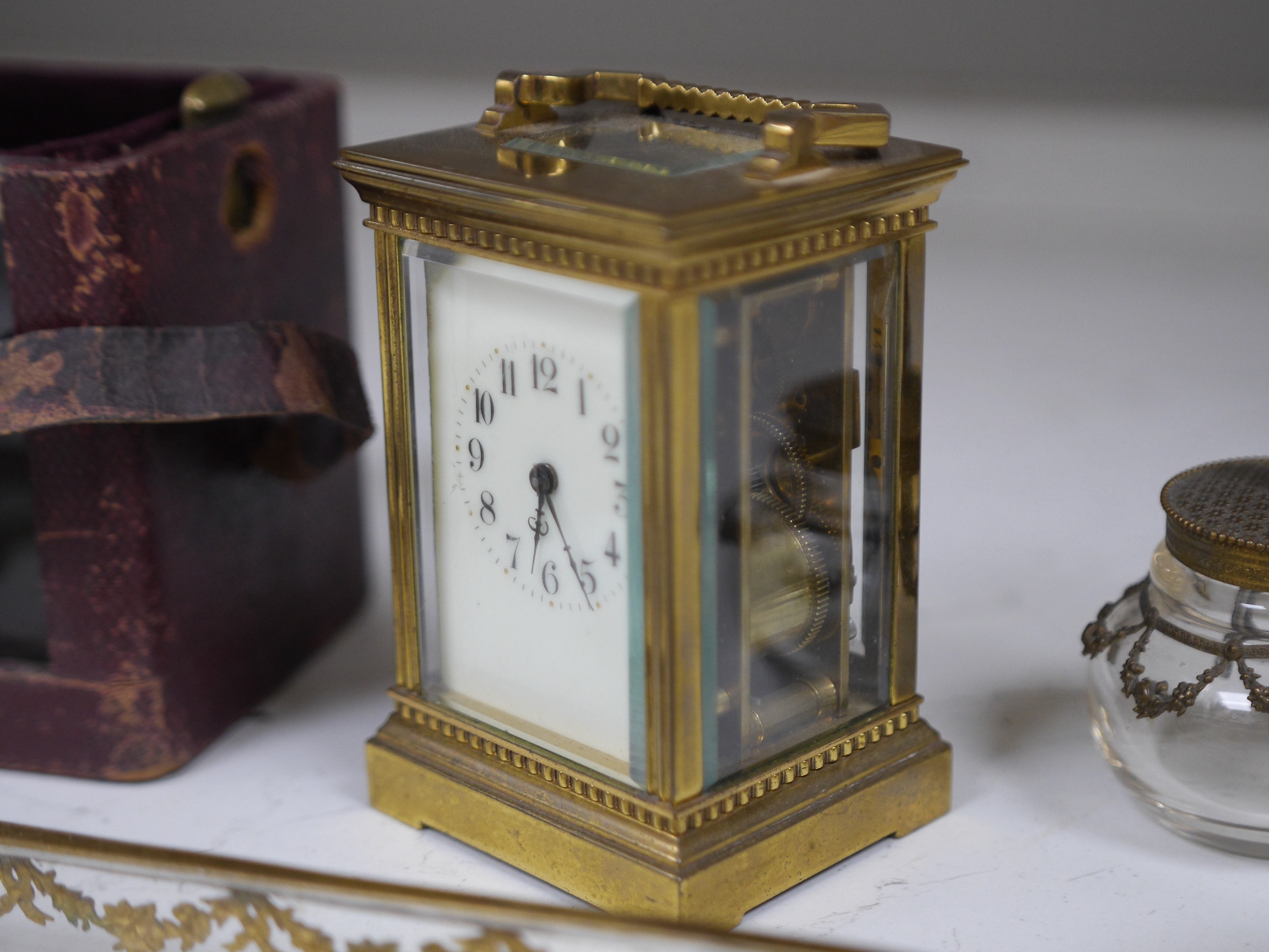 A brass cased carriage clock and five ormolu mounted glass desk accessories, clock 12cm high. Condition - unknown if clock working, desk accessories fair to good condition.